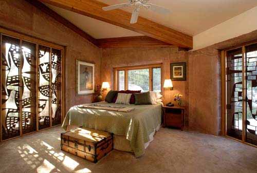 The master bedroom featuring beautifully textured and colored interior Poured Earth walls